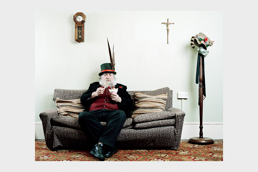 Jon Day Photography. Morris dancer on sofa.